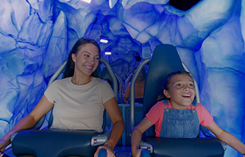 Guests riding Penguin Trek roller coaster